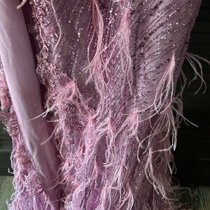 Perfect dress sequins and feathered bottom with small train